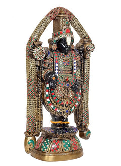 Front three-quarter view of multicolored idol statue with detailed crown and halo arch