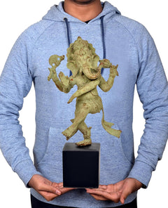 Bronze dancing Ganesha statue on dark wooden base held in hands