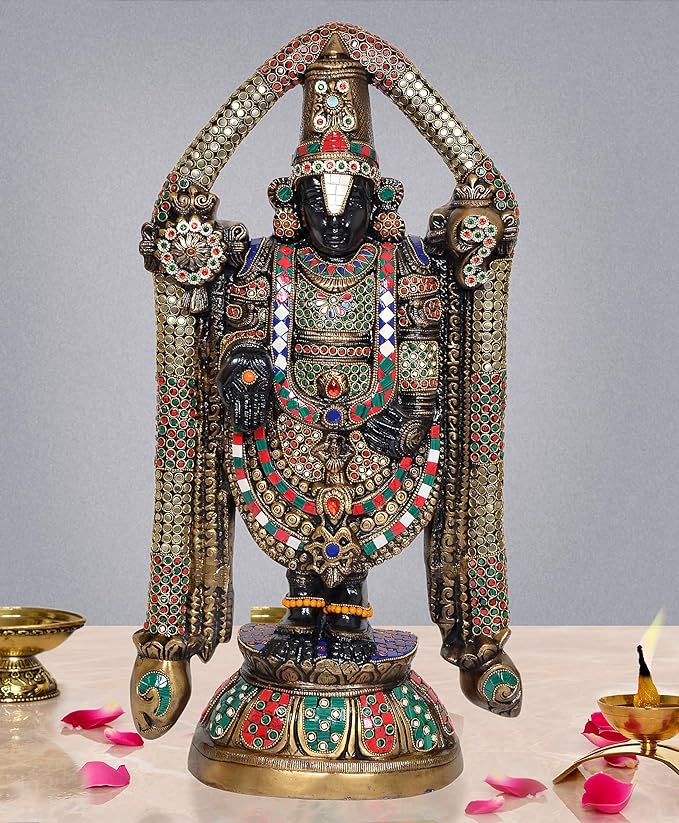 Multicolored brass idol statue with arched arms, ornate crown and jeweled garments
