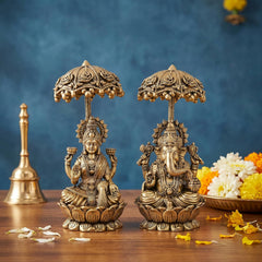 Brass Lakshmi and Ganesha statue pair with ornate decorative chatri over seated figures