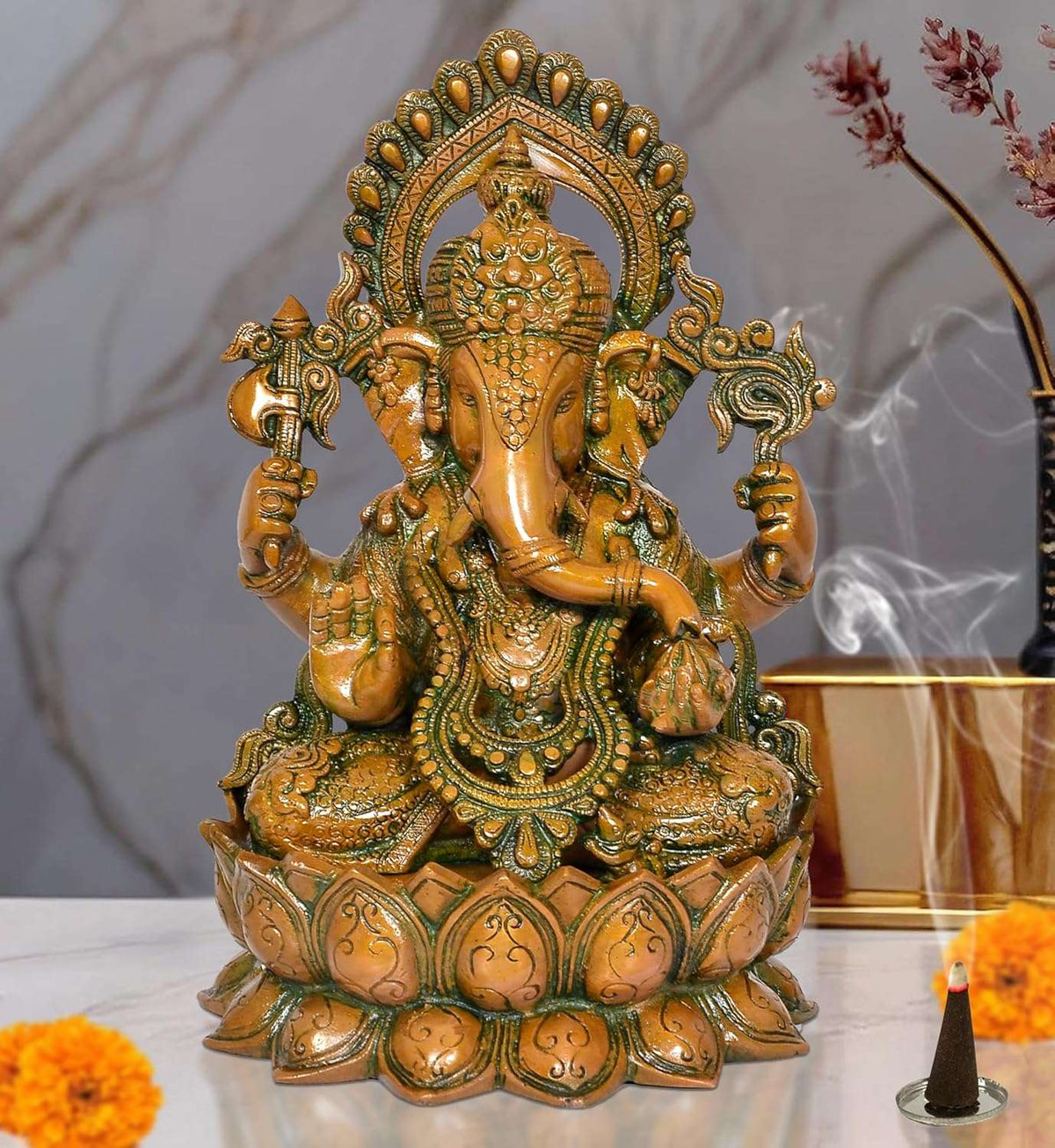 Brass Ganesha idol seated on lotus base, ornate crown and raised arms