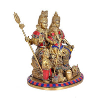 Brass Shiv Parivar statue from side view, tall central figure holding trident