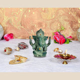 Grüne Ganesha-Idolstatue mit goldenen Augen, sitzende Figur mit vier Armen