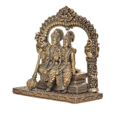 Brass Vishnu and Lakshmi statue, side view under decorative halo arch