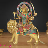 Brass Durga Maa statue riding a lion, ornate multi-color dress, holding trishul and weapons