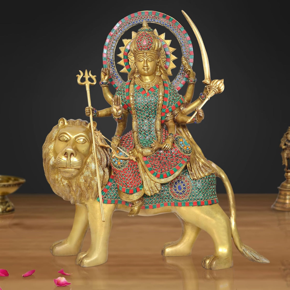 Brass Durga Maa statue riding a lion, ornate multi-color dress, holding trishul and weapons
