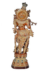 Rear view of brass Lord Krishna figurine, brown with circular halo and layered dress