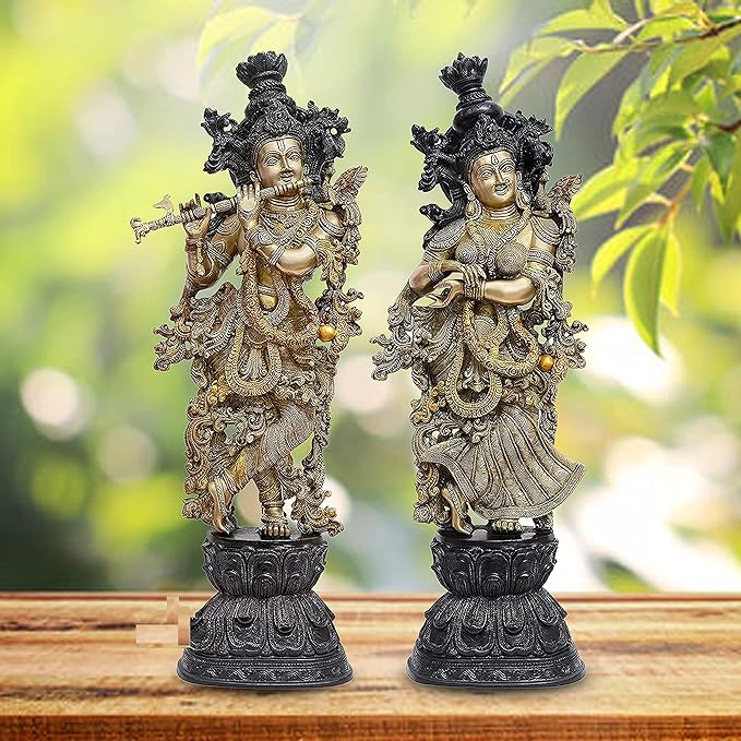 Brass Radha Krishna deity sculpture pair, standing on ornate dark pedestal