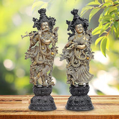 Brass Radha Krishna deity sculpture pair, standing on ornate dark pedestal