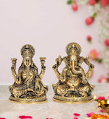 Brass Lakshmi and Ganesha idol set: Lakshmi seated with lamps, Ganesha seated with raised hands