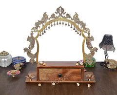 Brass-framed mandir with arched jali top and wooden base drawer, 20.5 in