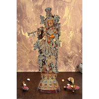 AONA brass Krishna figurine with ornate crown, holding flute, full-body standing on base