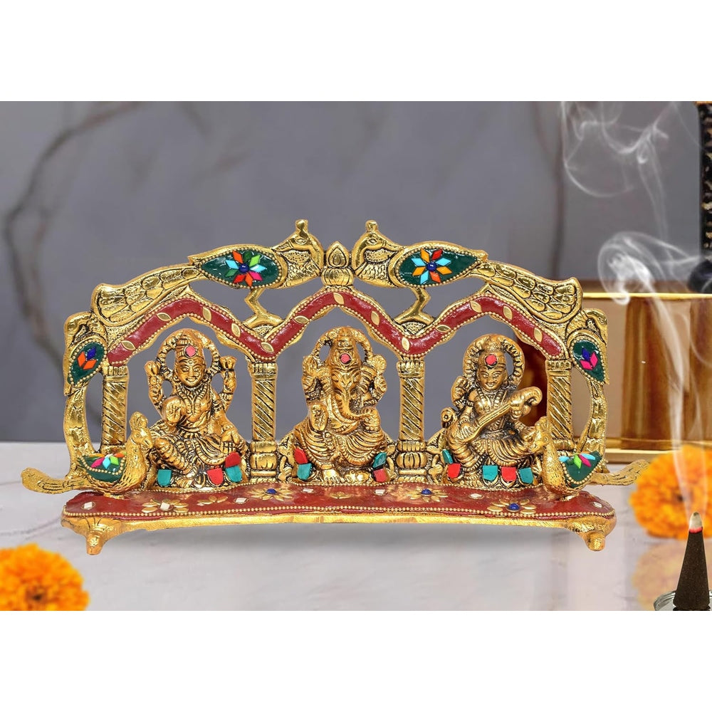 Metal idol of Ganesh, Laxmi, Saraswati with peacock arch frame, red and gold