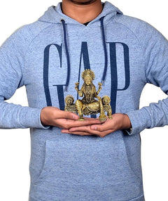 Mini brass Lakshmi idol in hands, seated blessing pose