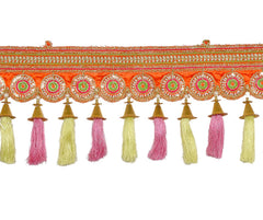 Orange toran border with repeating round designs and hanging gold-tipped tassels.