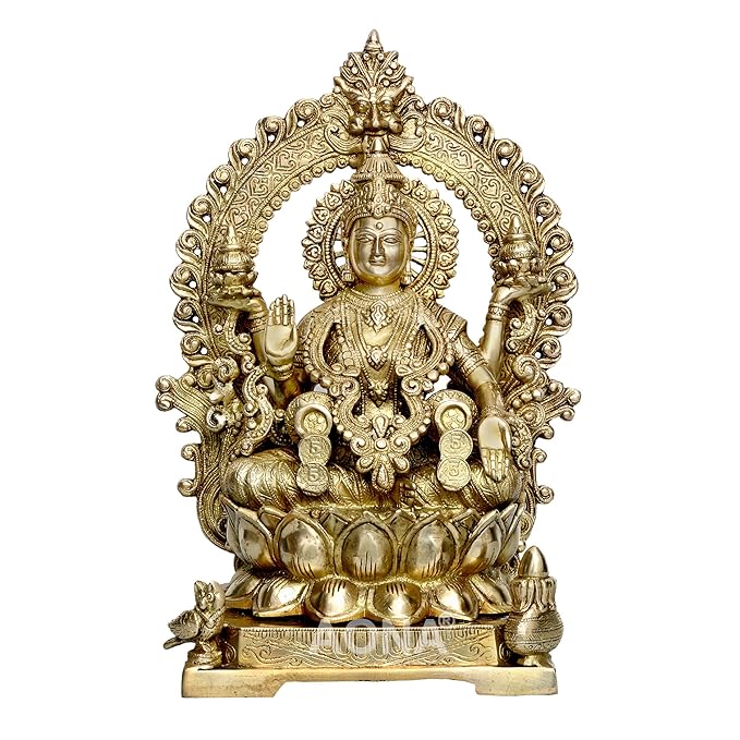 Brass Lakshmi idol with carved frame and Kirtimukha, seated on lotus