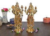 Gold-tone Vishnu Lakshmi idol statue, twin figure with raised hands, on pedestal