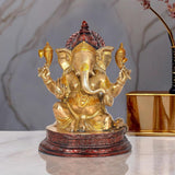 Brass Ganesha idol statue with raised arms and red engraved base, 10 inch