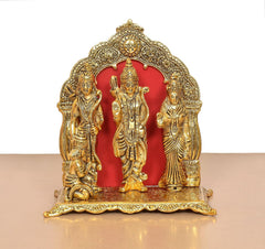 Ram Darbar statue front view: three gold-toned figures with red oval panel behind
