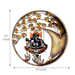 20-inch diameter round iron wall hanging of Ganesha on swing playing flute, leaf vines