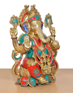 Brass Ganesha statue posed in profile, gold body with teal, red, and beaded trim