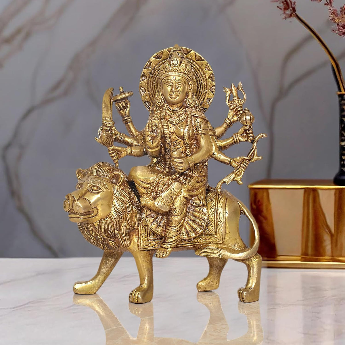 Brass Durga Maa idol seated on lion statue, multi-armed goddess figurine