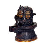 Brass Shiva linga statue three-quarter view with three faces and textured pedestal
