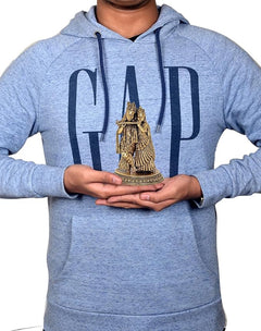 Radha Krishna brass idol held in hands, 6-inch height perspective