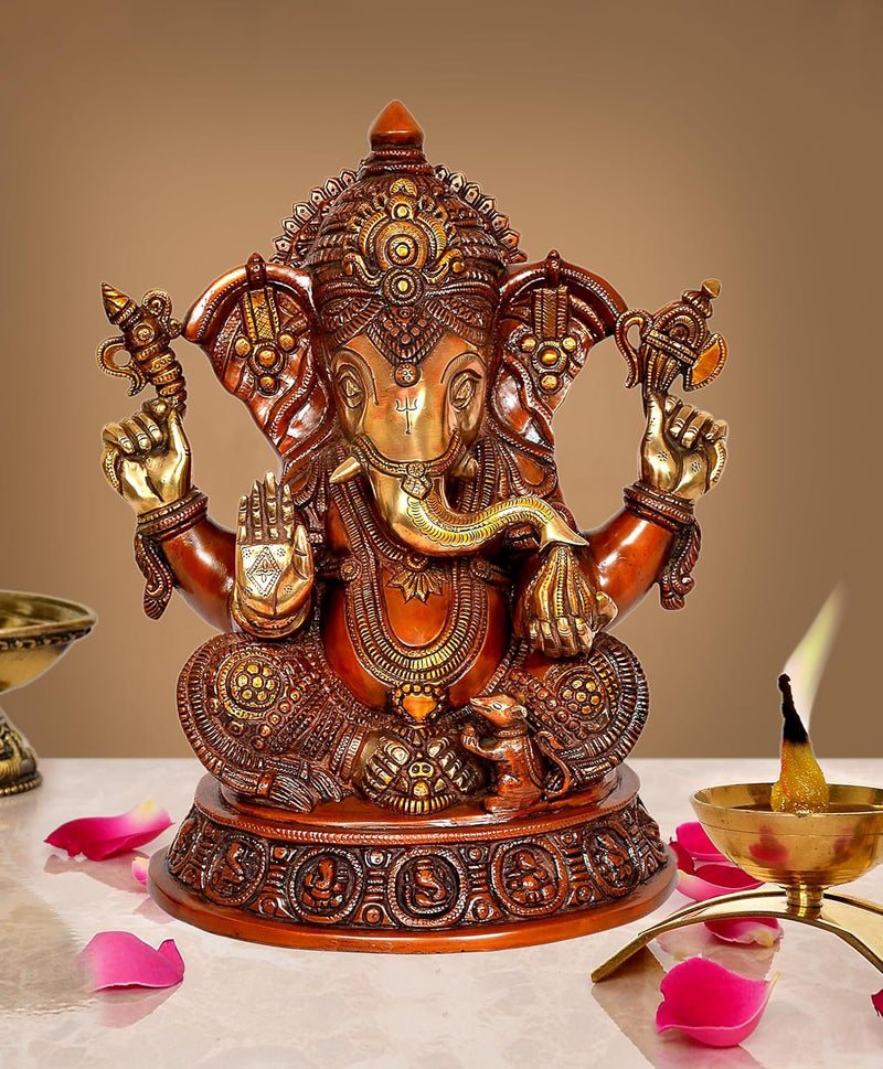 Brass Ganesha statue idol with seated figure and four raised arms, ornate gold detailing