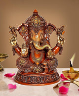 Brass Ganesha statue, seated with four arms, detailed crown and gold ornaments, 16 in