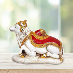 White Nandi polyresin statue, red-and-gold saddle, 7.5 in