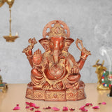 Brass Ganesh statue, 11 inch tall, seated with four arms and detailed engravings