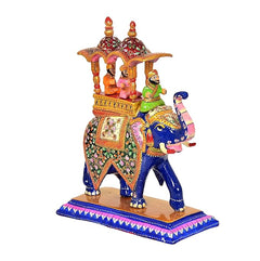 10-inch hand-painted wooden elephant with decorative howdah pillars and bright saddle panel