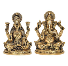 Brass Lakshmi and Ganesha statues, both seated with raised hands, detailed ornaments