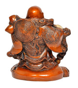 Back view of Laughing Buddha statue, brass-tone swirls and ornate orange base