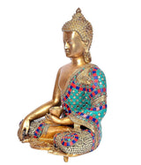 Brass Buddha statue side view, earth-touching gesture, detailed jeweled teal and red robe