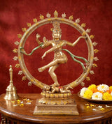Dancing Nataraj Shiva resin idol with gold finish, circular halo ring, seated on ornate base.