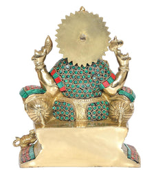 Back view of sitting Ganesha statue, gold-toned backplate with teal-green jeweled detailing