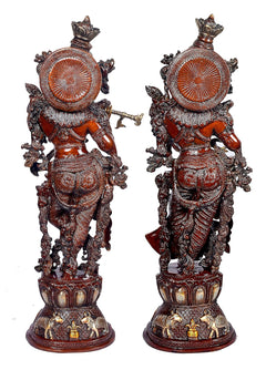 Back view of brass Lord Krishna showpiece with decorative circular back design