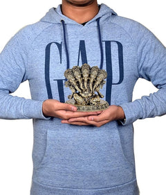 Brass Panchmukhi Ganesha idol held in hands, ornate multi-face design on base