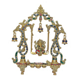 Brass Ganesha swing diya with bell frame, gold-tone arches, hanging bell row, enamel details