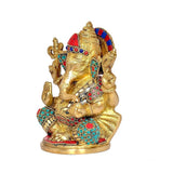 Side view 7-inch brass Ganesha statue with ornate jewel work in red, blue and turquoise