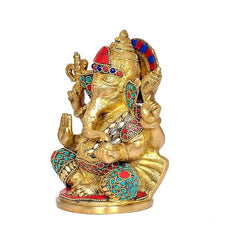 Side view 7-inch brass Ganesha statue with ornate jewel work in red, blue and turquoise