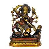 Brass Mahishasura Mardini figurine with trident on dark base, ornate arms and jewelry