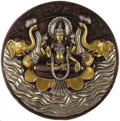 Brass wall hanging plate: Lakshmi with four arms, flanked by elephants, ornate rim