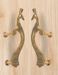 Gold brass peacock door handle pair, long curved design with textured scales and beak details