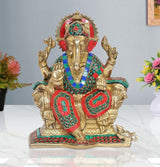 Brass Ganesha idol sitting with jeweled red, teal, and gold crown and four raised arms