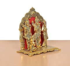 Ram Darbar statue angled view: ornate golden arch with three figures on raised base
