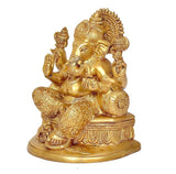 Brass Ganesha statue seated on carved base, one hand raised