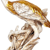Close-up resin saras crane figurine with detailed white wings and golden accents